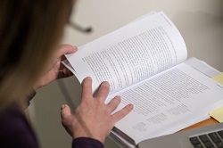 Image of a woman reading a textbook