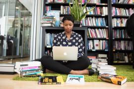 Image of lady sitting down with a laptop