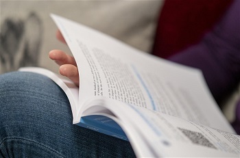 Image of a student reading a textbook