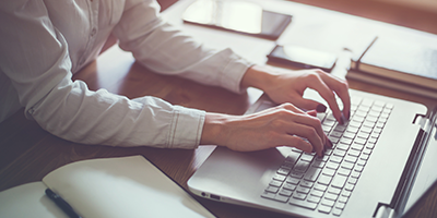 Photo of a person using a laptop
