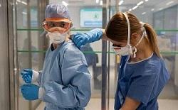 Image of two healthcare workers in full PPE