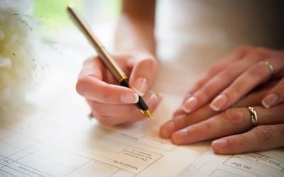 Hands signing wedding registration