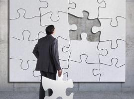 Image of man holding a large puzzle piece