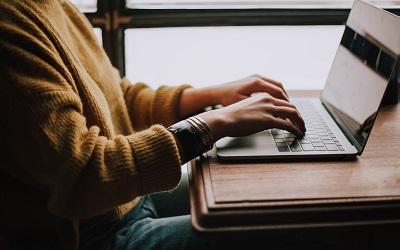 Photo by Christin Hume on Unsplash - person typing on a laptop