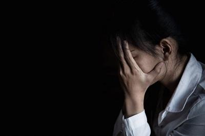 Woman holding her head in her hands