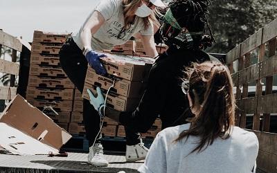 Photo by Joel Muniz on Unsplash - charity workers unloading boxes