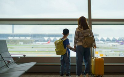 child and adult at an airport 