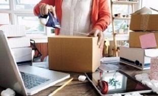 Image of a small business owner sealing a cardboard box