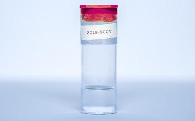 Photo by Vincent Ghilione on Unsplash - small bottle with a label on it saying 2019-NCOV on