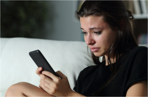 Woman with phone looking upset